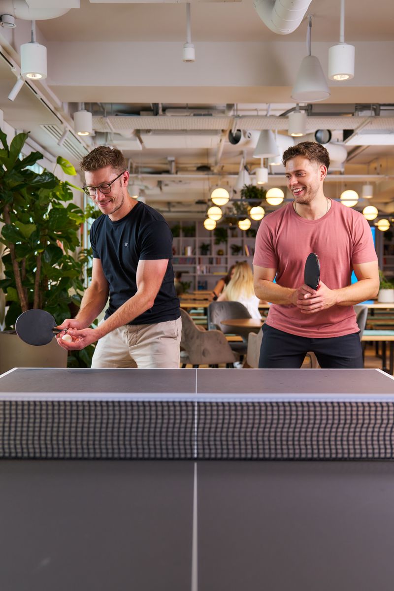 Staff members playing table tennis.